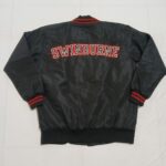 Back view of black Swinburne bomber jacket with large embroidered university lettering