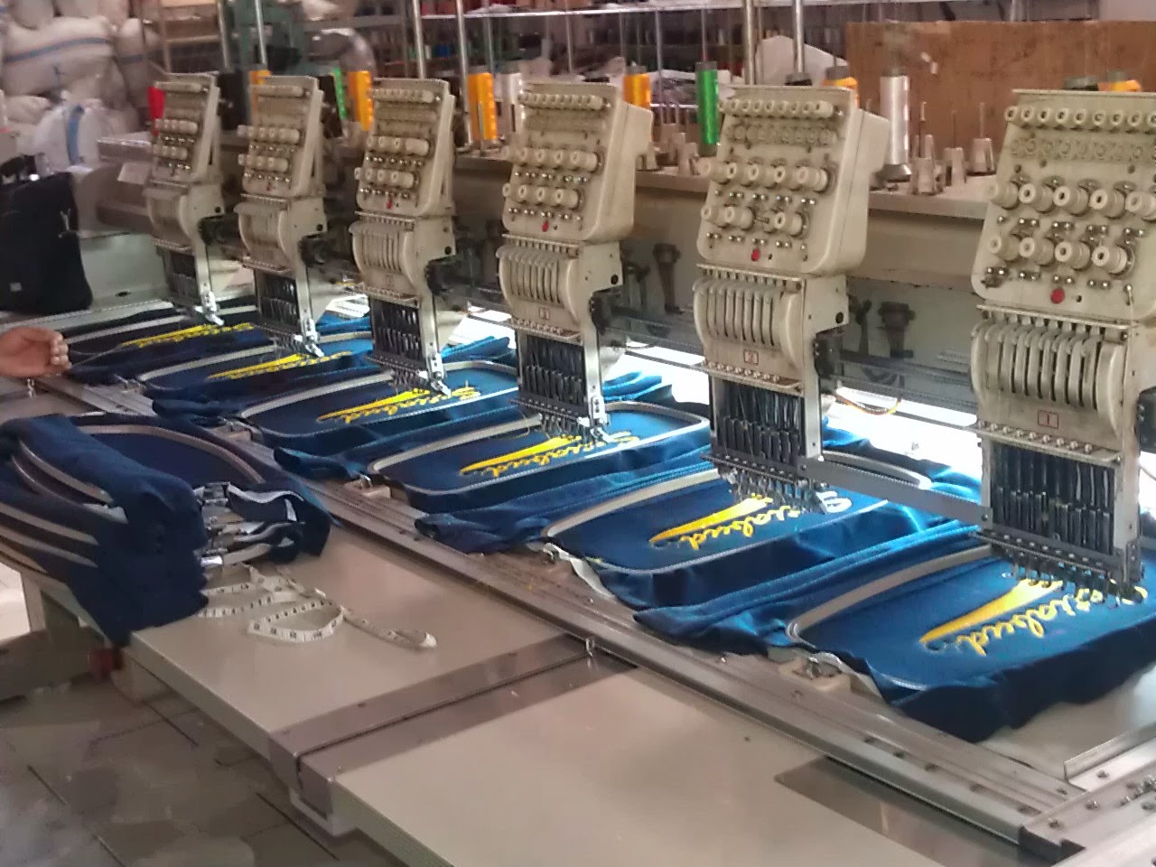 Computerised embroidery machine producing a custom jacket logo