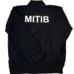 Back view of black custom bomber jacket with large white MITIB lettering
