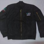 Black custom bomber jacket with gold zipper and embroidered corporate chest logo