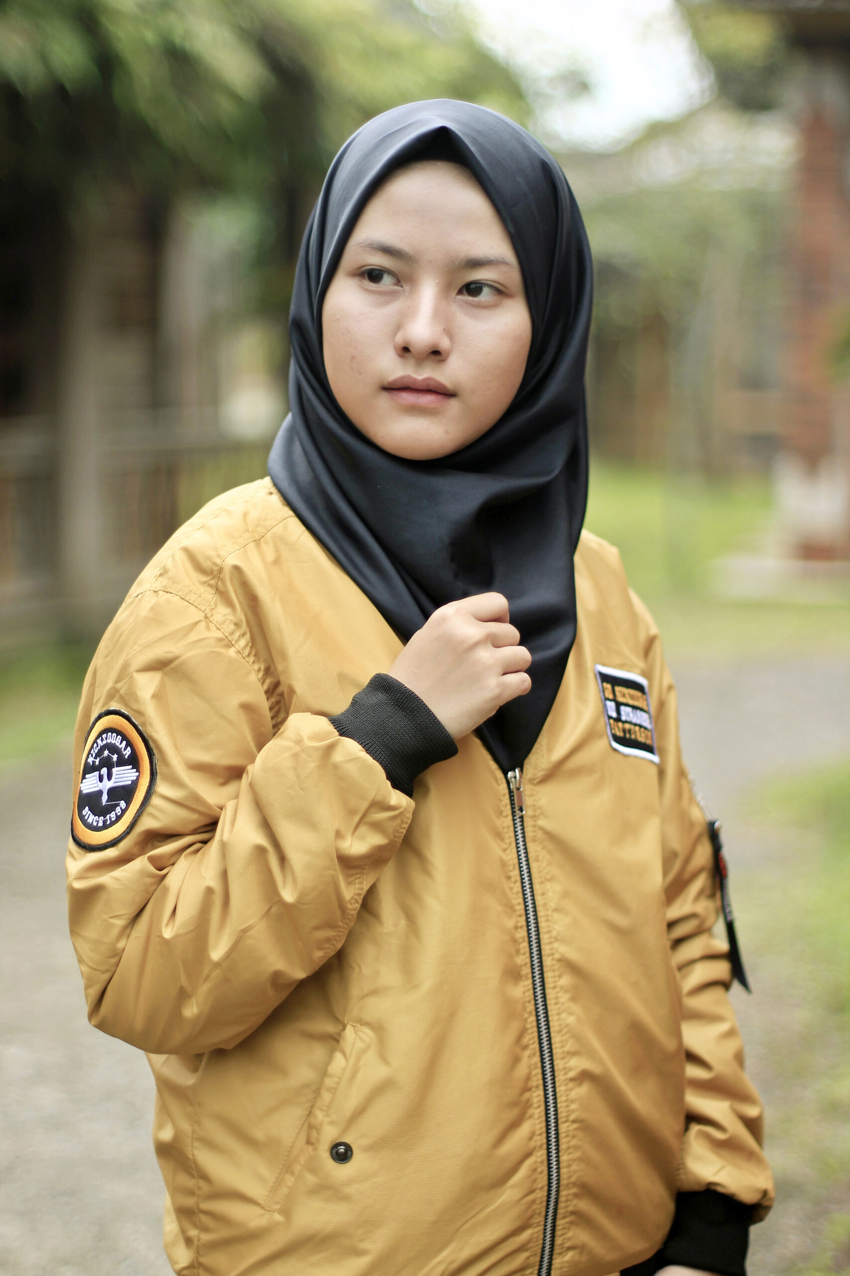 Gold Custom Bomber Jacket Woman wearing a custom gold bomber jacket